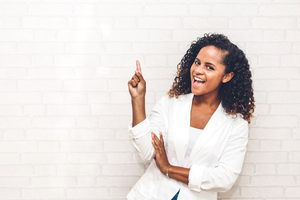 Smiling African American Black Woman Pointing to Empty Copy Spac